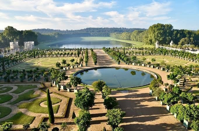 The Orangery parterre at Versailles looking toward a long lake framed by trees